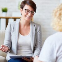 Successful psychologist talking to her patient